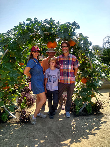Family under the growing pumpkin