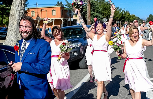 Parade: Bridesmaids wave their noisemakers