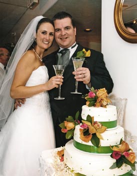 Julie & Matt toasting the wedding cake