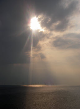 sun breaking through clouds leaving Liverpool