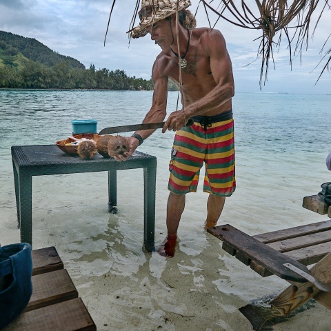 cutting coconut in the ocean