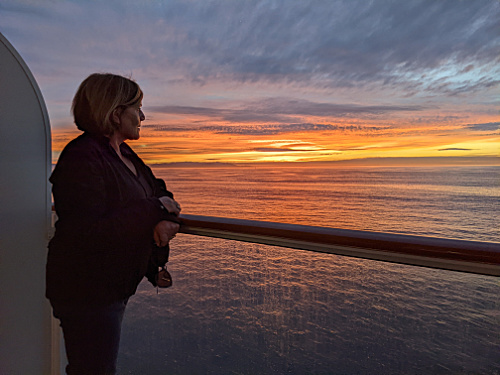 Patty on cabin balcony at sunset