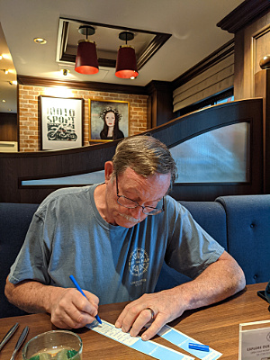 Craig in pub with luggage tags