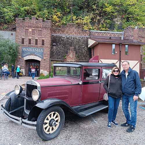 Classic auto in front of caves